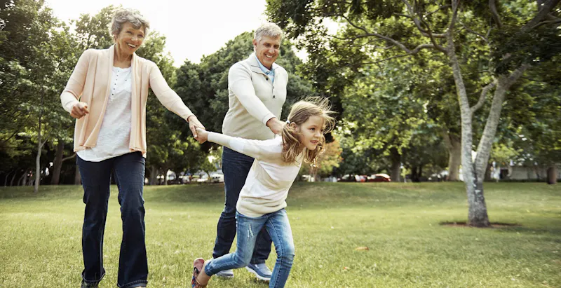 grandparents running with granddaughter